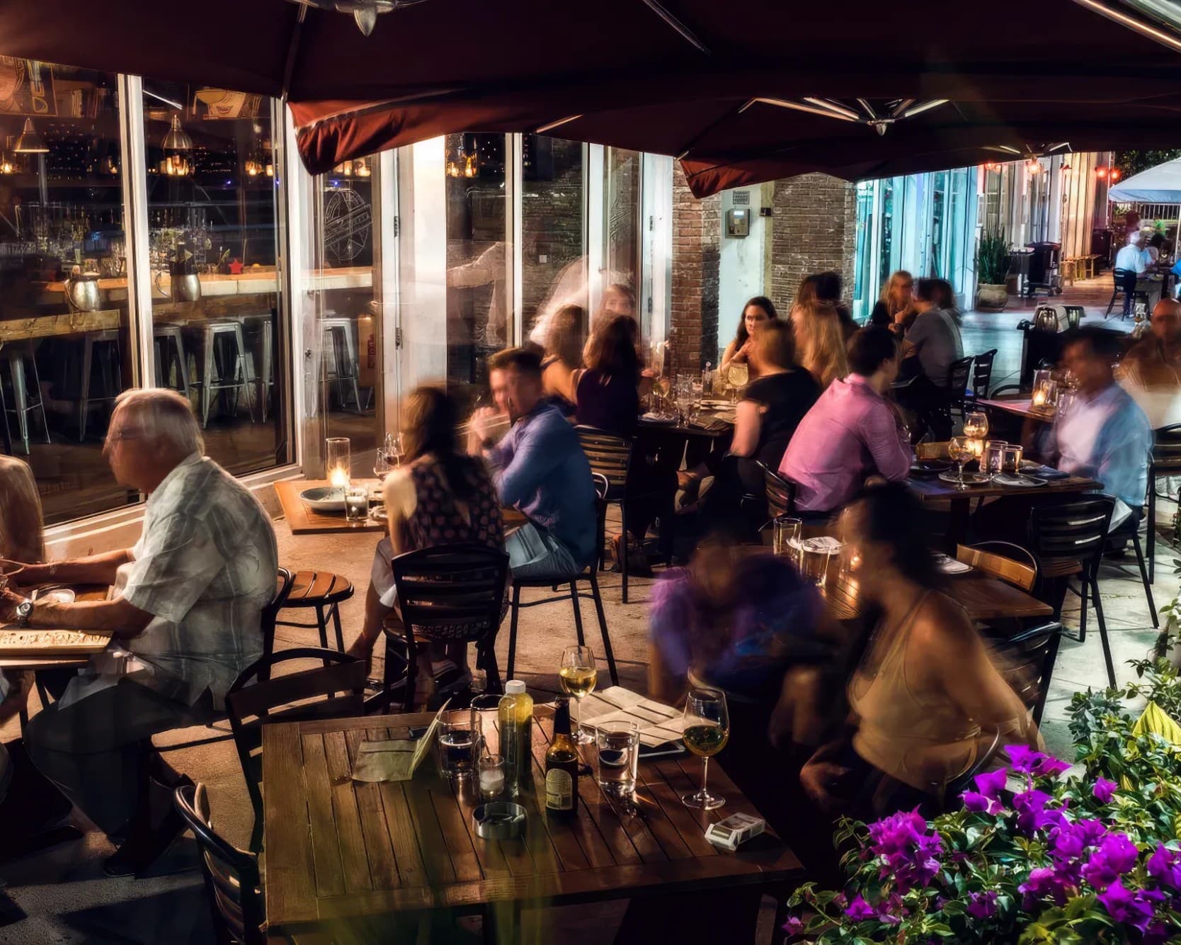 Diners at candlelit tables on Barceloneta’s terrace in Sunset Harbour at night