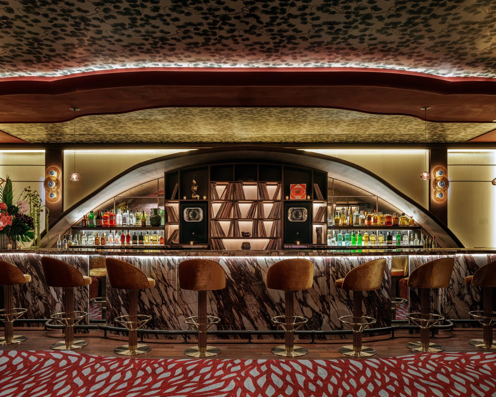 Bar Shishi lounge in Miami Beach with a curved backlit bar and red patterned carpet